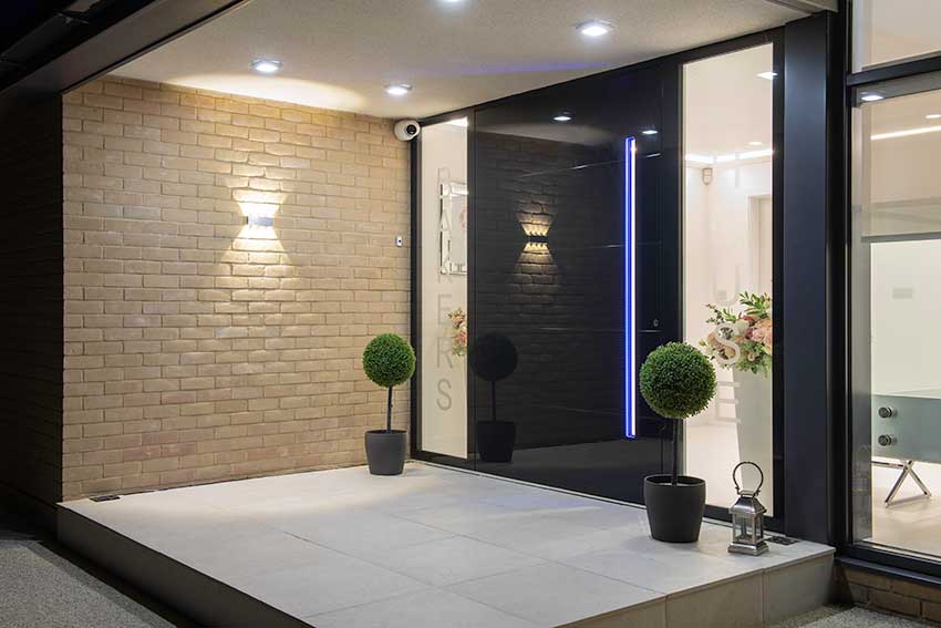 Glass faced pivot door with LED lights recessed handle outside